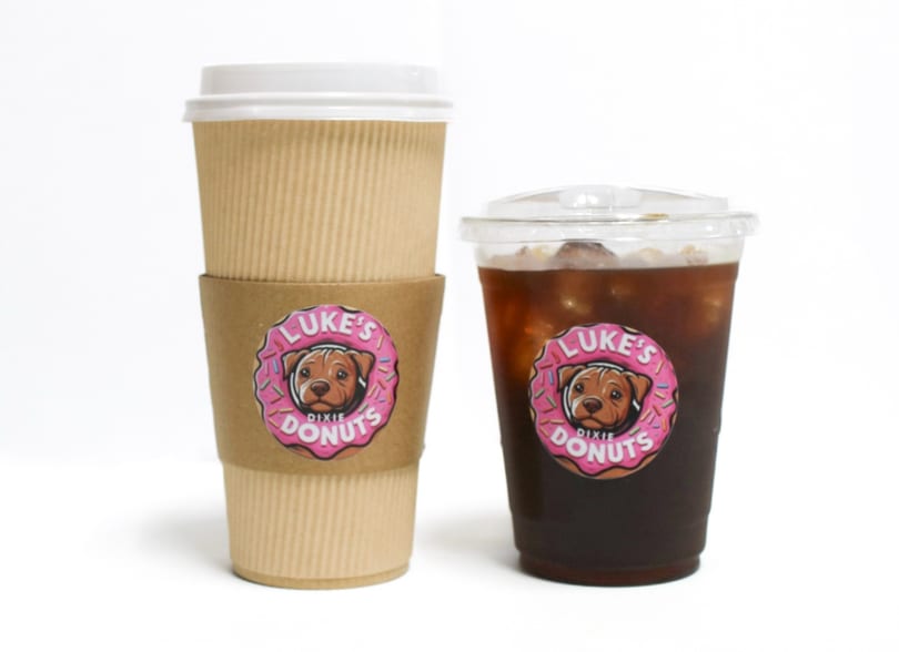 Two Luke's Dixie Donuts branded coffee cups, one hot and one iced, on a white background.